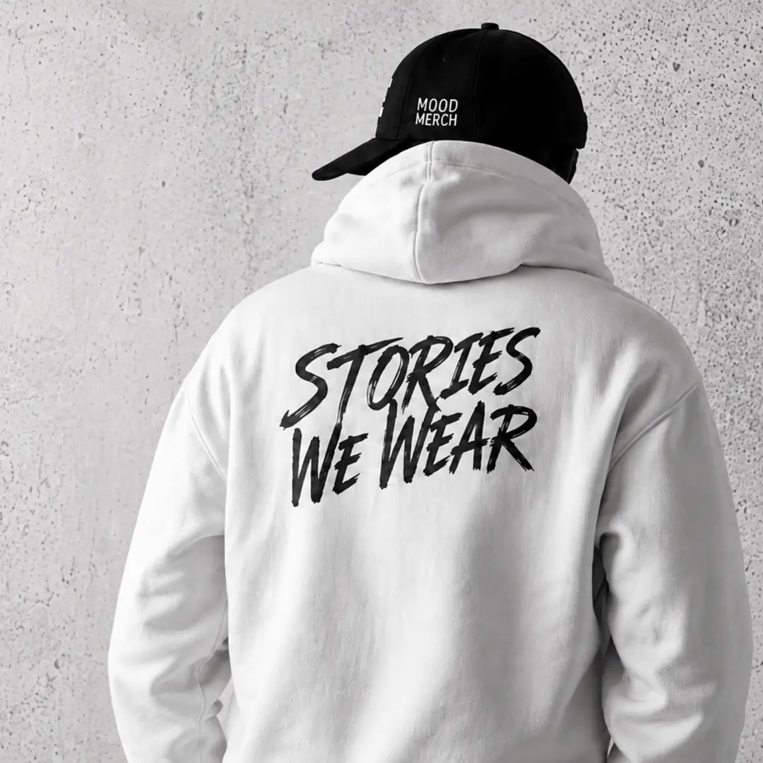 Model wearing a white Mood Merch Stories We Wear hoodie